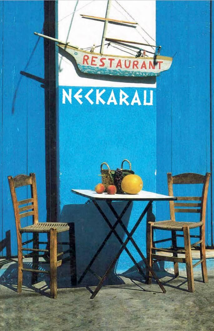 Griechische Stühle vor dem gemalten Logo des Restaurant Neckarau